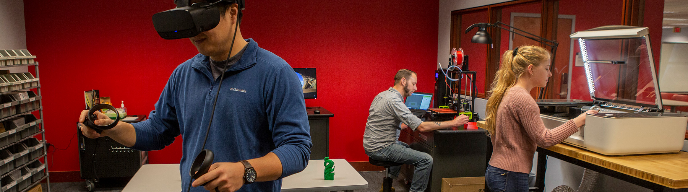 A photo of the TML maker space with people using the available equipment.